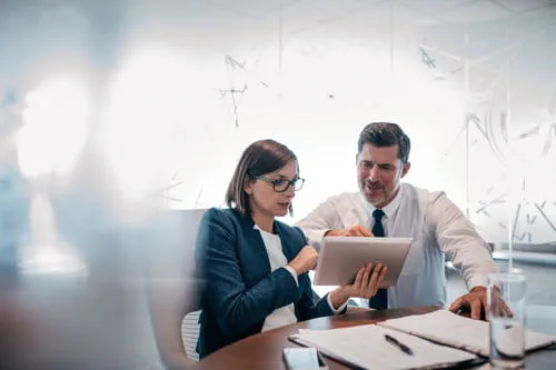 Two businesspeople looking at a report Two businesspeople looking at a report