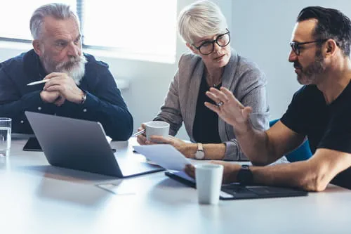 Three colleagues in an office meeting Three colleagues in an office meeting
