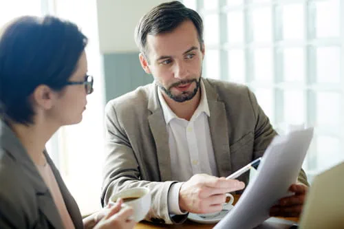 Two colleagues looking at a report