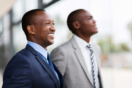 Two businessmen smiling