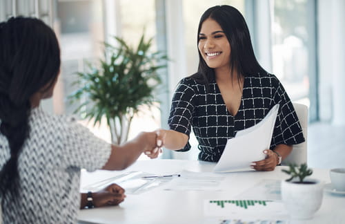 Two businesswomen shaking hands