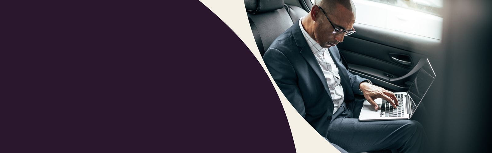 Bannière de présentation : un homme dans une voiture travail sur son ordinateur