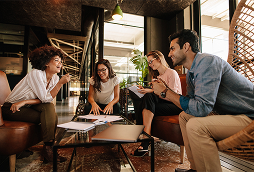 Four people working around a table, smiling and talking about Effective Leadership Handoff Four people working around a table, smiling and talking about Effective Leadership Handoff