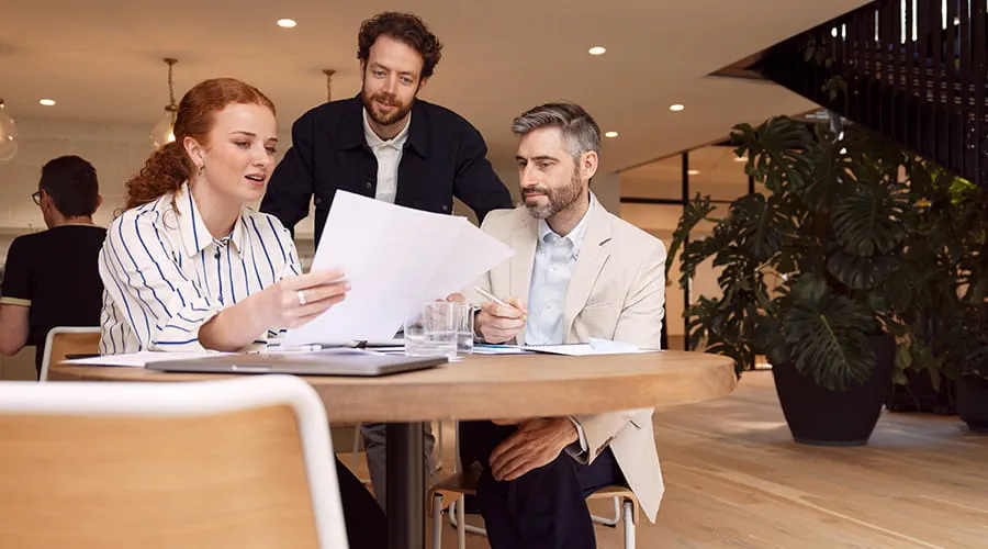 Three colleagues in an office meeting Three colleagues in an office meeting