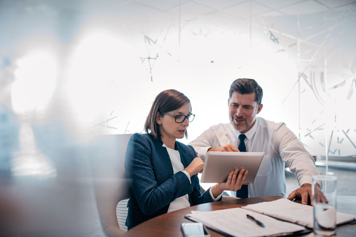 Two businesspeople looking at a report Two businesspeople looking at a report