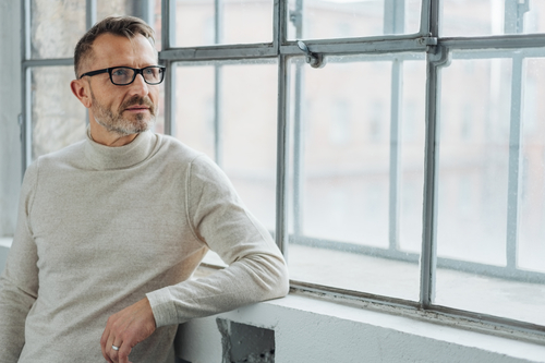 senior businessman sitting by a window senior businessman sitting by a window