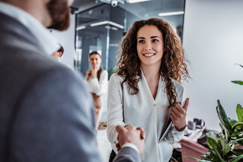 businesswoman shaking businessman's hand businesswoman shaking businessman's hand