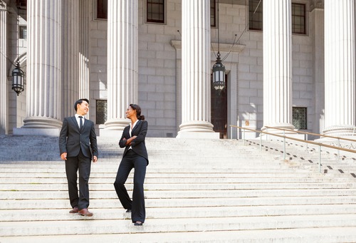 two businesspeople standing on the stairs