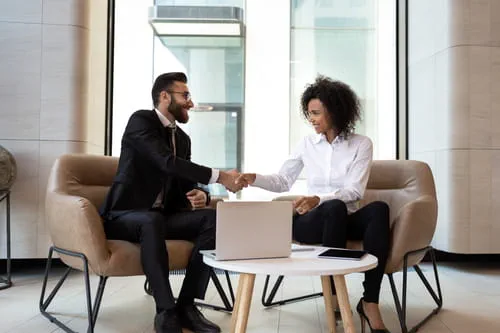 two businesspeople shaking hands two businesspeople shaking hands