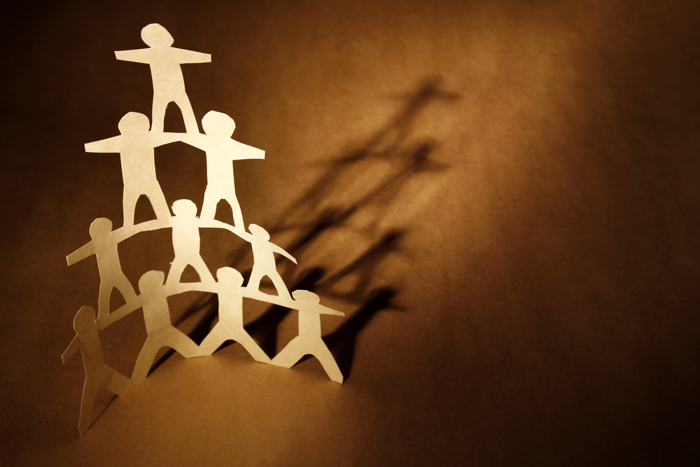 paper cutout of human pyramid