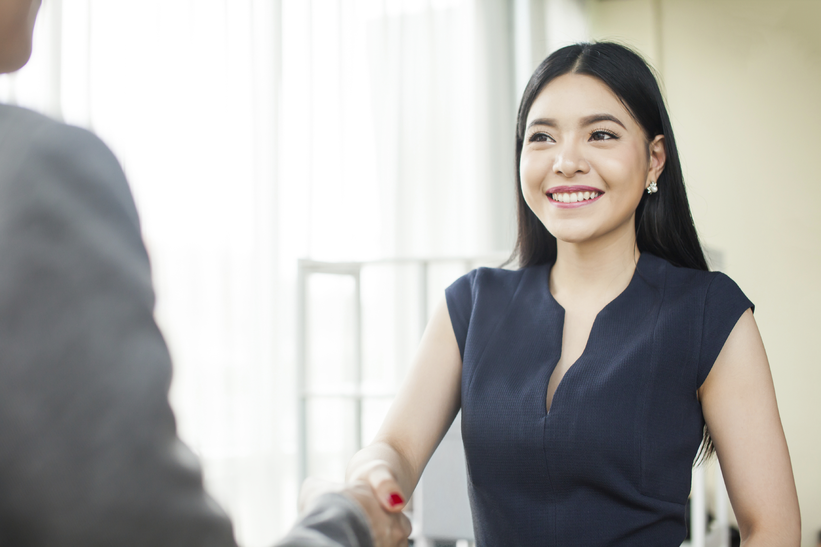 woman shaking man's hand enthusiastically