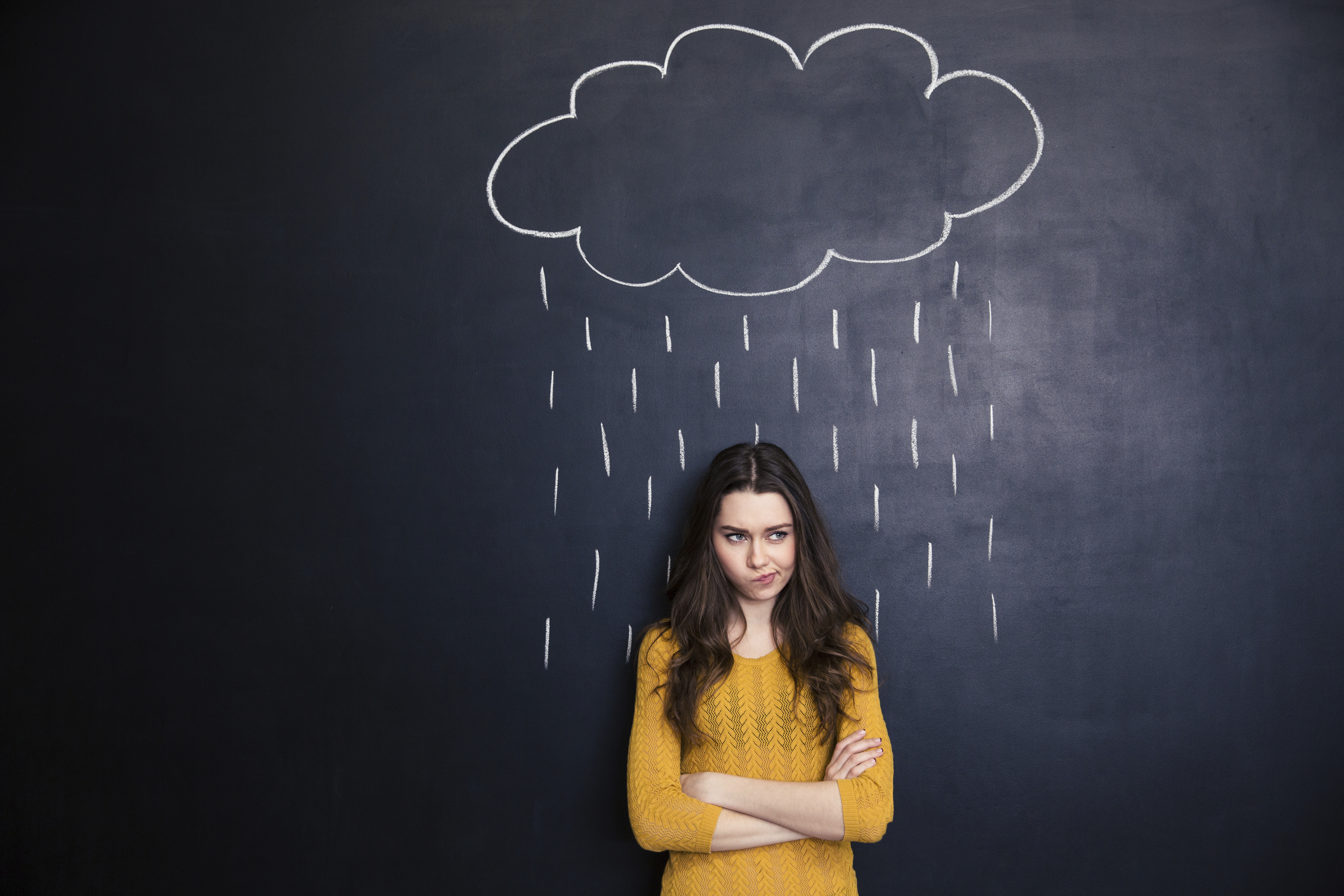 girl standing under rain cloud