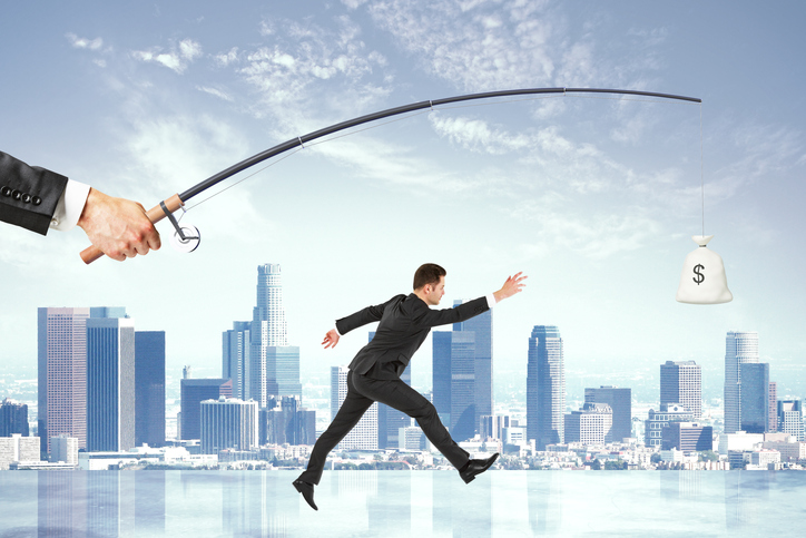 employee going after money on a fishing line