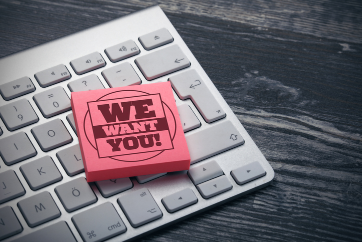"we want you" post-it note on keyboard
