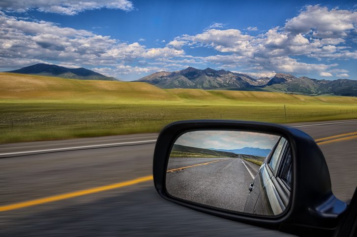 looking back in rear view mirror