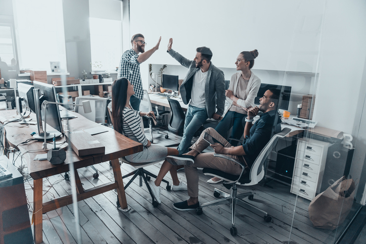 team of coworkers congratulating each other