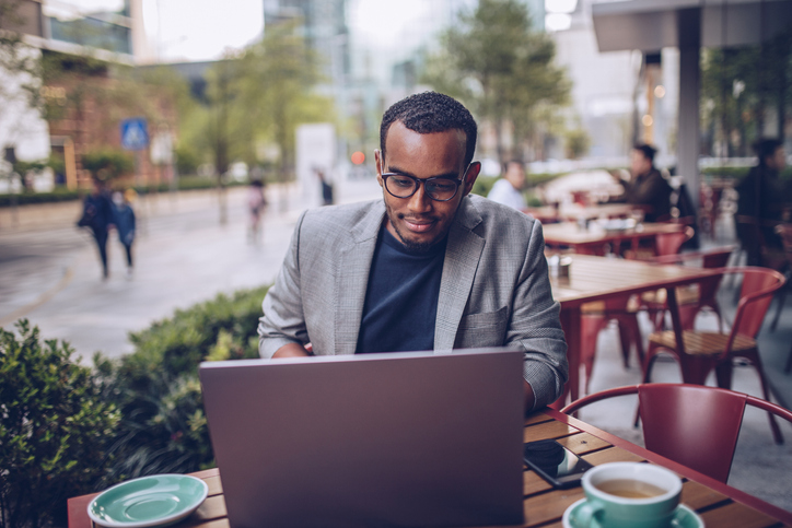 man working at an outdoor cafe