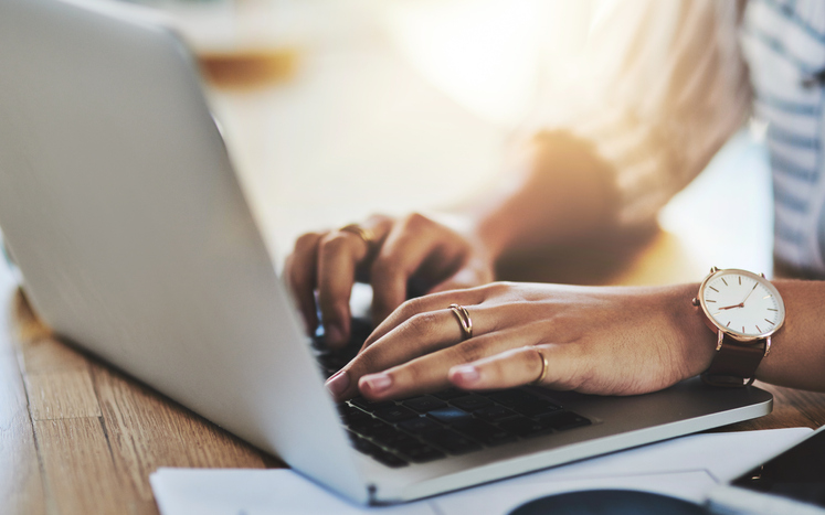 sitting at a computer typing