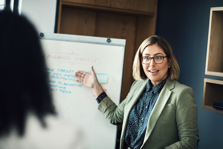 woman presenting to colleagues
