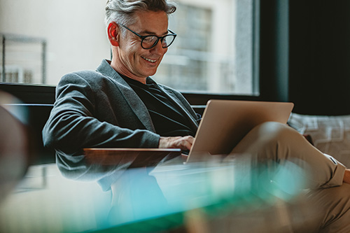 smiling-businessman-sitting-office-lobby-working