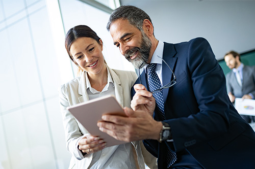 happy-business-colleagues-modern-office-using