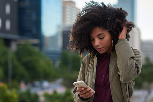 african-american-woman-using-smartphone-city